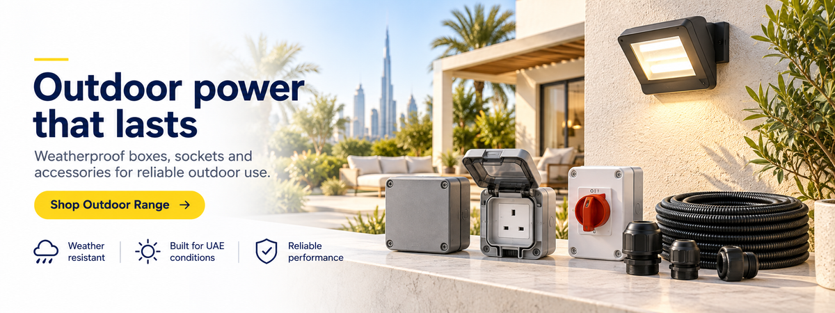 Outdoor power adapters, weatherproof boxes, and a coiled black cable displayed on a patio ledge in front of a modern house and pool area. Large promotional text on the left reads 'Outdoor power that lasts' with feature icons for weather resistance, UAE suitability, and reliable performance.