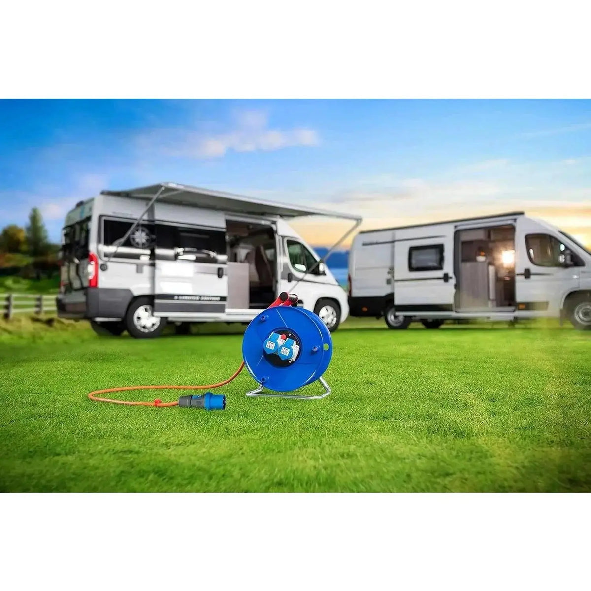 Brennenstuhl Garant blue 2-socket cable reel on grass with 25m cord, camping vans in background UAE