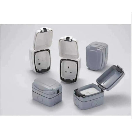 MK Electric Masterseal weatherproof compact 3-gang 2-way switch 86403GRY; grey enclosures with open lids, five units. UAE