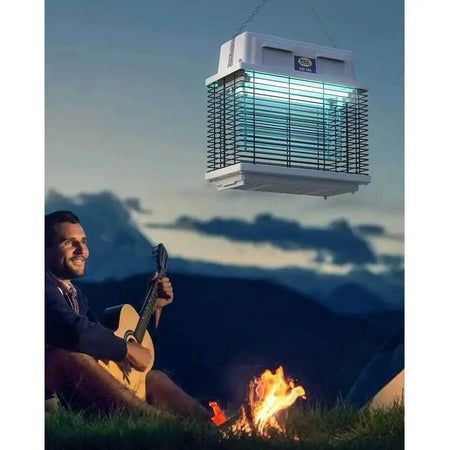 Mo-el Cri Cri 309 UV-A electric bug zapper hanging over a campsite as a man plays guitar. UAE