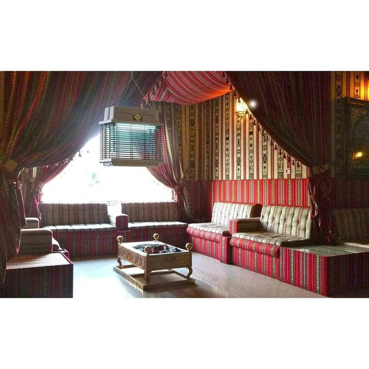 Mo-el Cri Cri 309 UV-A insect killer, ceiling-hung above a red patterned Moorish-style lounge. UAE